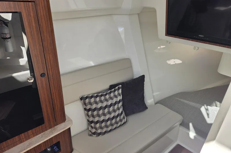 Slide: The Image of 2020 Pursuit DC 365 Dual Console interior with seating, cushions, and TV. - 68