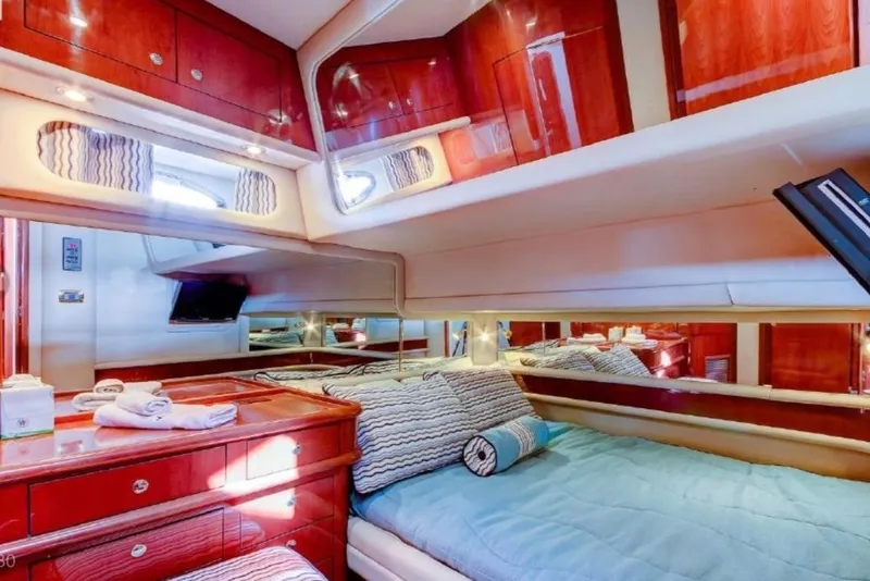 Slide: The Image of Luxurious cabin interior of 2002 Sea Ray 550 Sedan Bridge yacht with wood finish. - 13