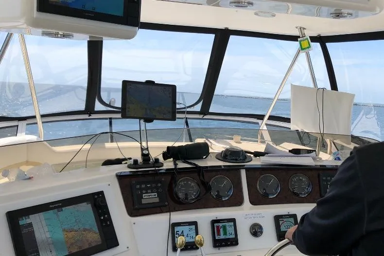 Slide: The Image of Cockpit view of 2002 Sea Ray 550 Sedan Bridge with navigation equipment and ocean horizon. - 17