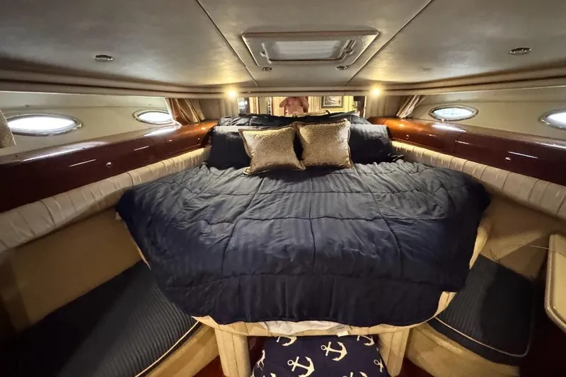Slide: The Image of Luxurious bedroom interior of 2002 Sea Ray 550 Sedan Bridge yacht with elegant bedding. - 3