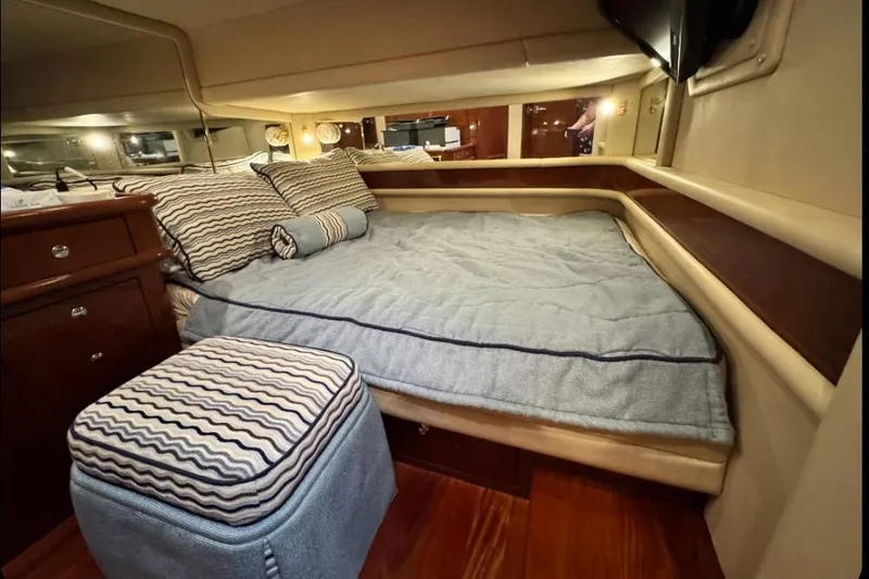 Slide: The Image of Cozy bedroom interior of 2002 Sea Ray 550 Sedan Bridge yacht with plush bedding. - 4