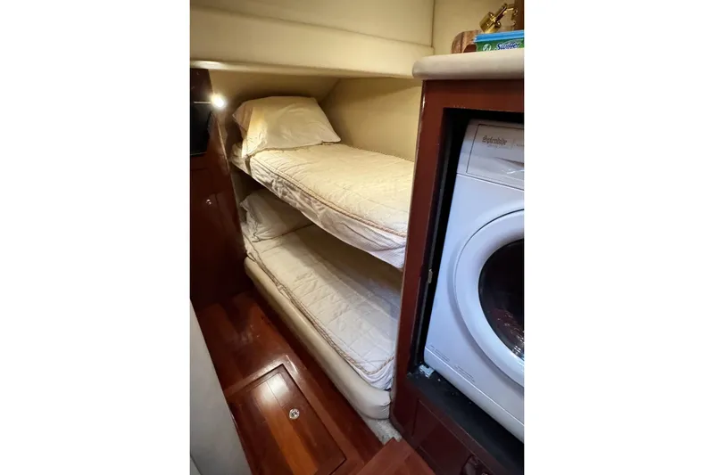 Slide: The Image of Interior of 2002 Sea Ray 550 Sedan Bridge with bunk beds and washing machine. - 5