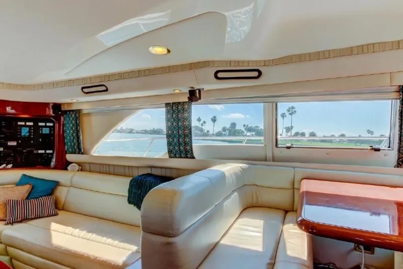 Slide: The Image of Luxurious interior of 2002 Sea Ray 550 Sedan Bridge yacht with plush seating and ocean view. - 7