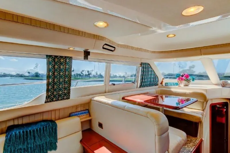 Slide: The Image of Luxurious interior of 2002 Sea Ray 550 Sedan Bridge yacht with elegant seating and scenic views. - 8