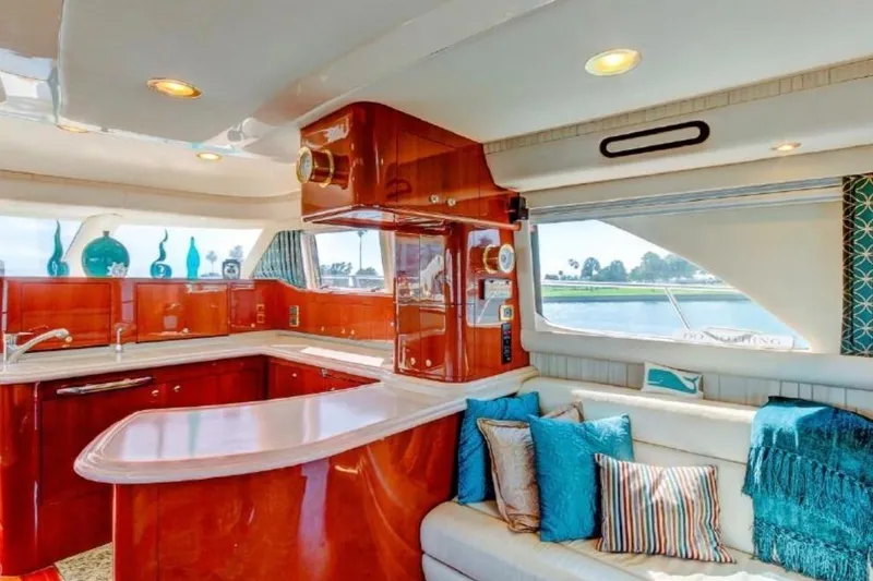 Slide: The Image of Luxurious interior of 2002 Sea Ray 550 Sedan Bridge yacht with elegant wood finishes. - 9
