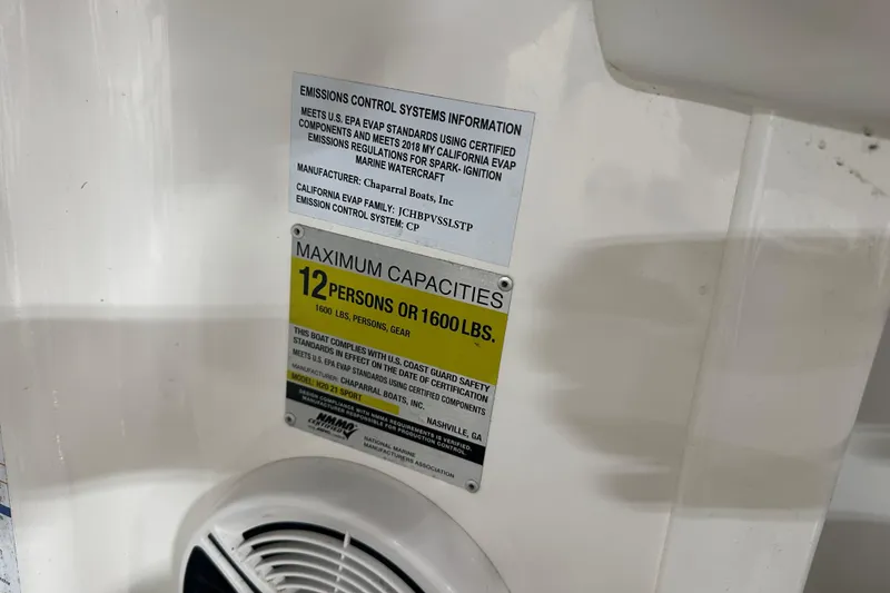 Slide: The Image of 2018 Chaparral 21 H2O Sport capacity label, 12 persons or 1600 lbs, emissions info. - 10
