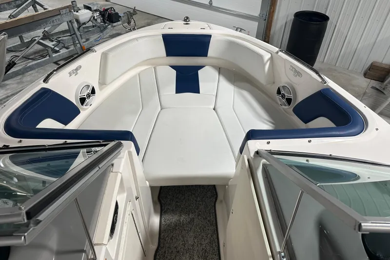 Slide: The Image of 2018 Chaparral 21 H2O Sport boat interior with white and blue seating. - 11