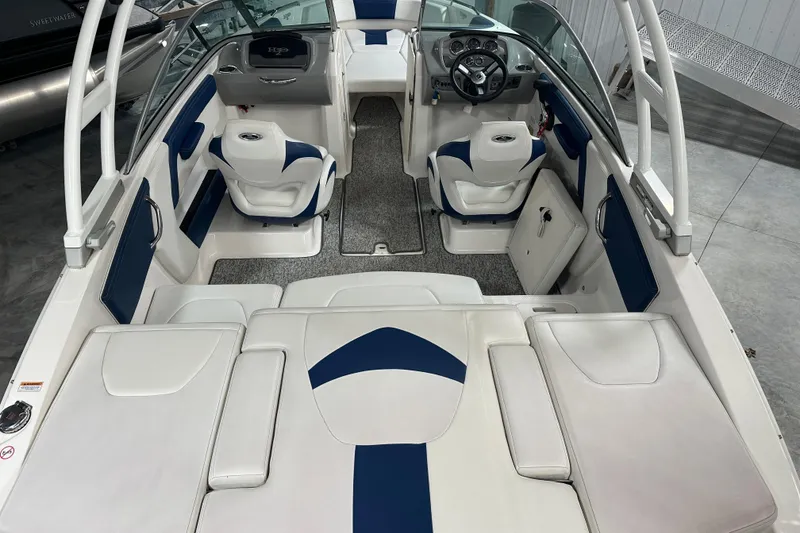 Slide: The Image of 2018 Chaparral 21 H2O Sport boat interior with white and blue seating. - 3