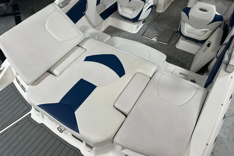 Slide: The Image of 2018 Chaparral 21 H2O Sport boat interior with white and blue seating. - 5