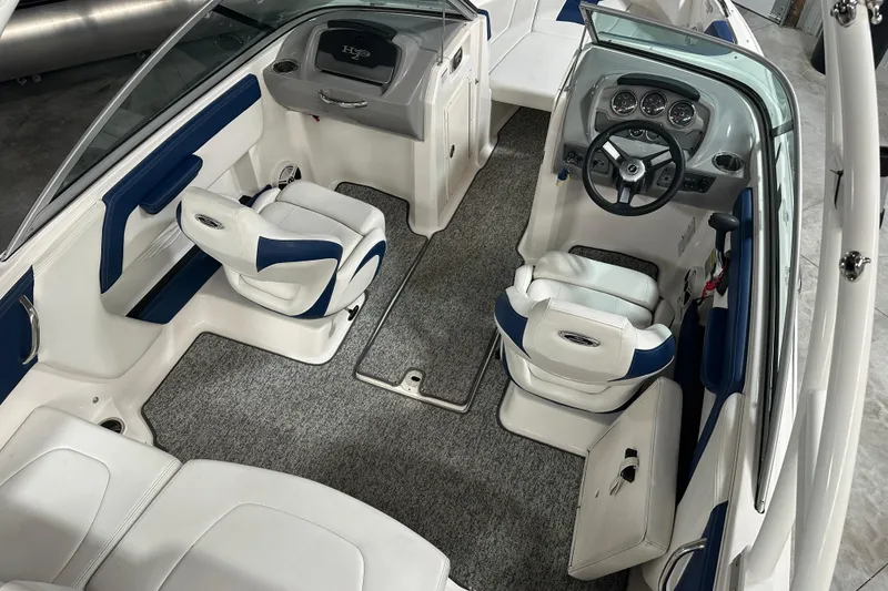 Slide: The Image of 2018 Chaparral 21 H2O Sport boat interior with dual seating and modern dashboard. - 6
