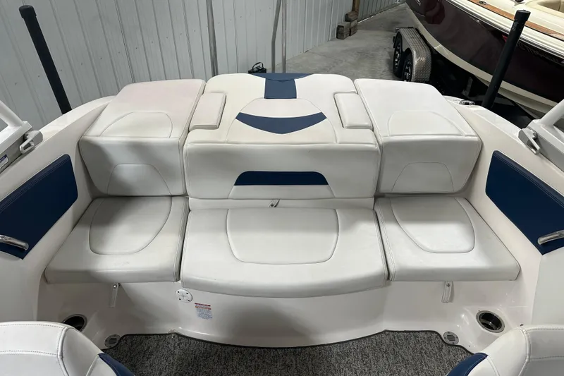 Slide: The Image of 2018 Chaparral 21 H2O Sport boat interior with white and blue seating. - 7
