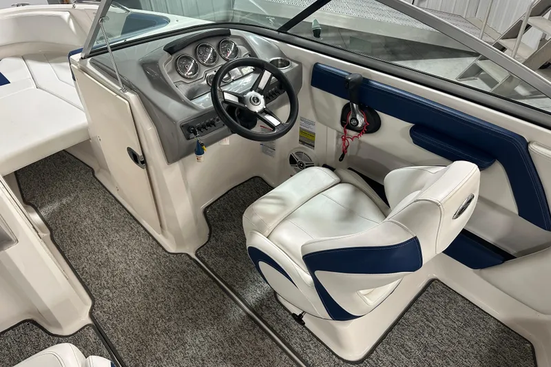 Slide: The Image of 2018 Chaparral 21 H2O Sport boat interior with steering wheel and seating. - 8