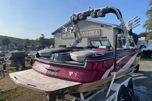 Slide: The Image of 2013 MasterCraft X-25 boat with wakeboard tower, parked at marina. - 16