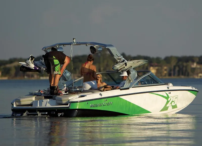 Slide: The Image of 2013 MasterCraft X-25 boat on calm water, featuring people enjoying a sunny day. - 17