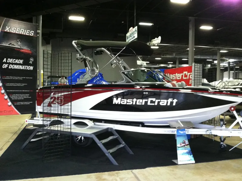 Slide: The Image of 2013 MasterCraft X-25 boat displayed indoors at a boat show. - 24