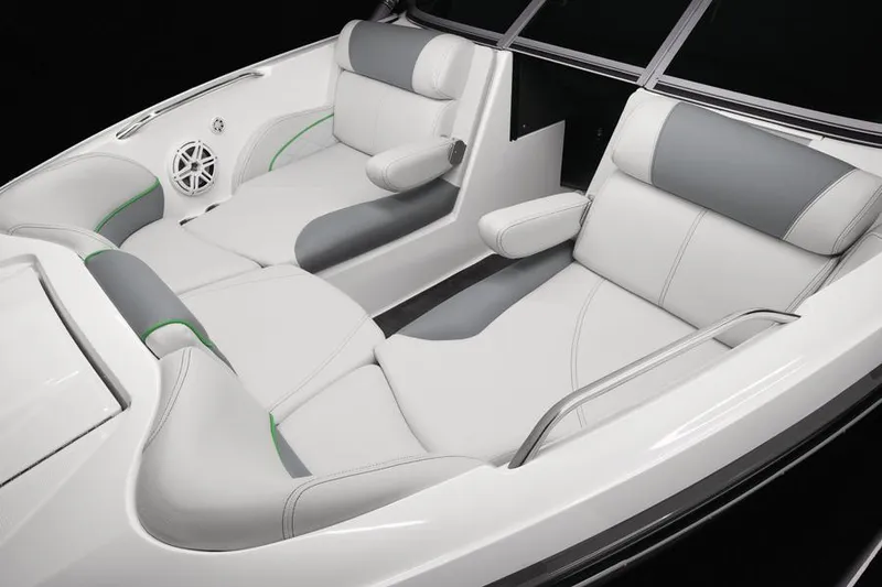 Slide: The Image of 2013 MasterCraft X-25 boat interior with white and gray seating, featuring armrests and speaker. - 28