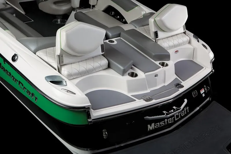 Slide: The Image of 2013 MasterCraft X-25 boat interior with white and gray seating, green accents. - 30