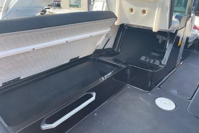 Slide: The Image of 2013 MasterCraft X-25 boat interior with red and gray seating, steering wheel, and dashboard. - 8