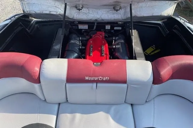 Slide: The Image of 2013 MasterCraft X-25 boat interior storage compartment with open seating and sleek design. - 9