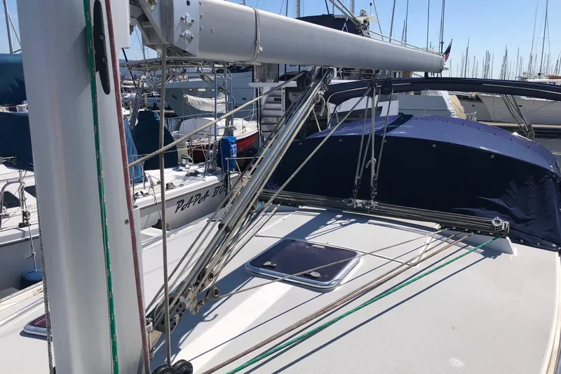 Slide: The Image of 2008 Catalina 42 MkII sailboat deck with rigging and blue canvas cover. - 16