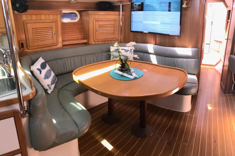 Slide: The Image of Interior of 2008 Catalina 42 MkII yacht with cozy seating and wooden table. - 2