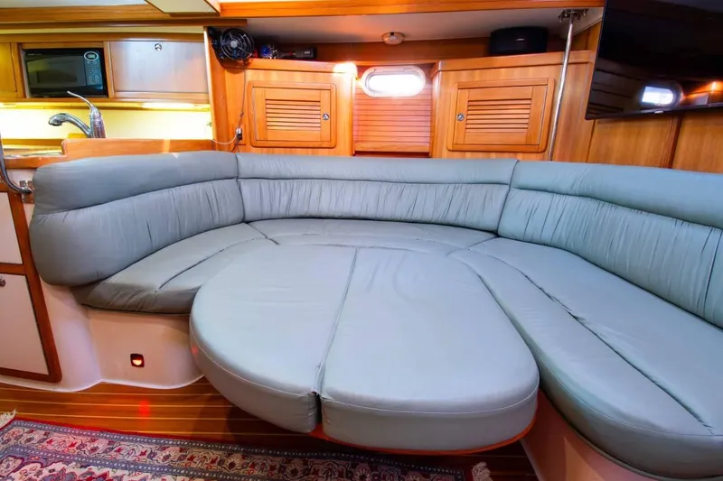 Slide: The Image of Luxurious interior of 2008 Catalina 42 MkII yacht with plush seating and wooden cabinetry. - 4