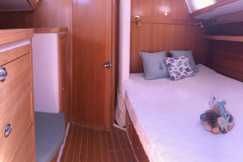 Slide: The Image of Cozy cabin interior of 2008 Catalina 42 MkII sailboat with wooden finish and comfortable bedding. - 5