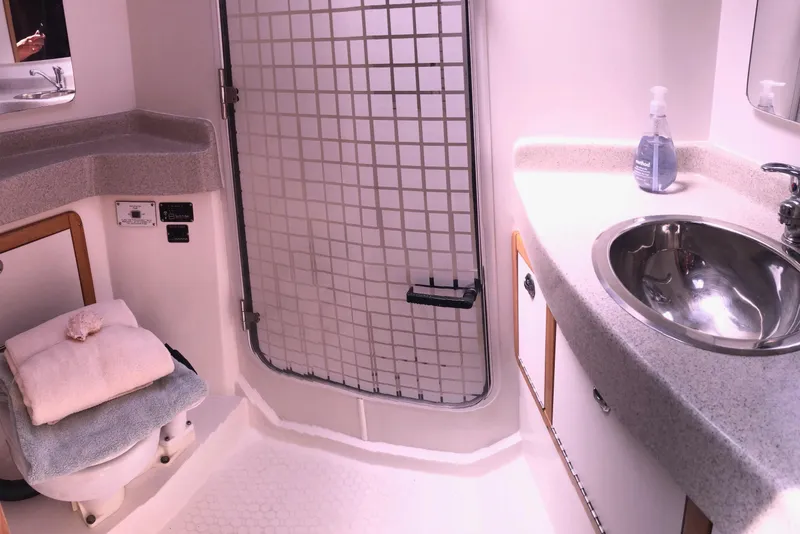 Slide: The Image of 2008 Catalina 42 MkII yacht bathroom with sink, toilet, and storage cabinets. - 6