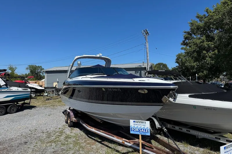 The Image of 2015 Formula 310 Bowrider boat for sale, displayed on a trailer under clear blue sky. - 0