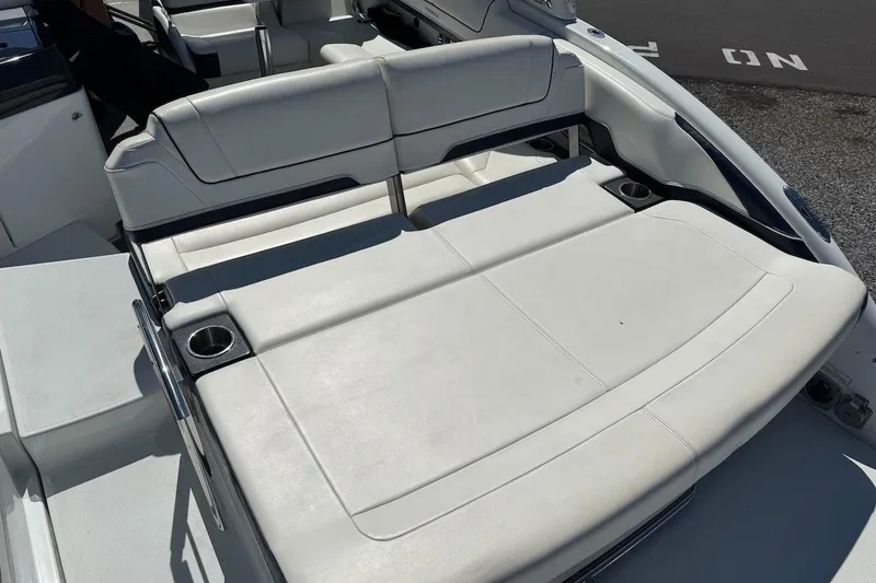 Slide: The Image of 2015 Formula 310 Bowrider boat interior with white seating and cup holders. - 15
