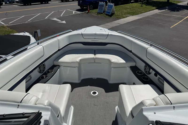 Slide: The Image of 2015 Formula 310 Bowrider boat interior with white seating and cup holders. - 16