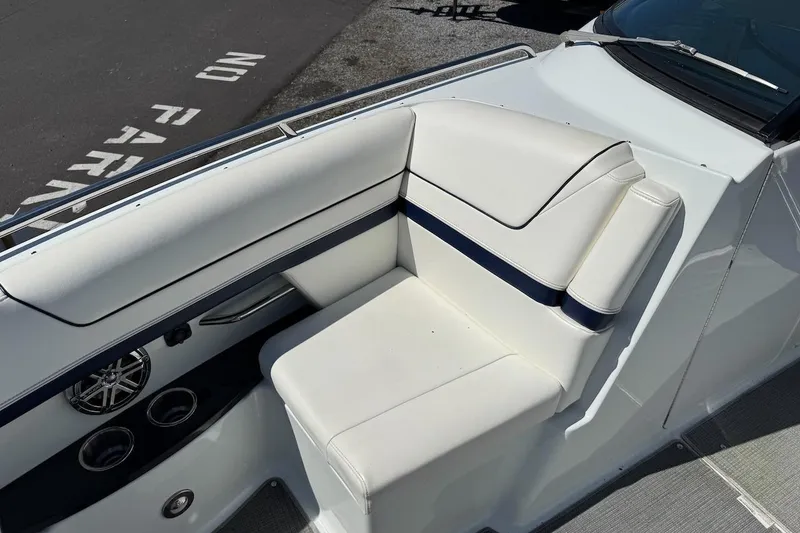 Slide: The Image of 2015 Formula 310 Bowrider boat interior with white seating and cup holders. - 18