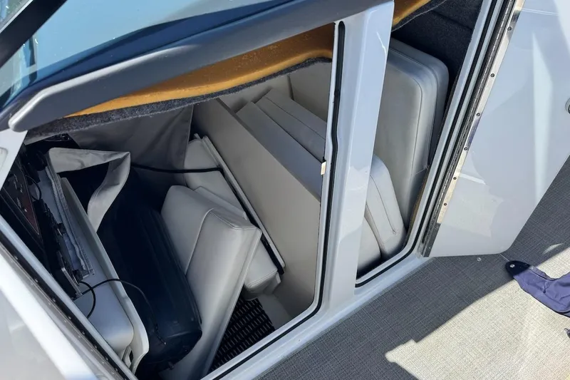 Slide: The Image of 2015 Formula 310 Bowrider storage compartment with cushions and equipment. - 22