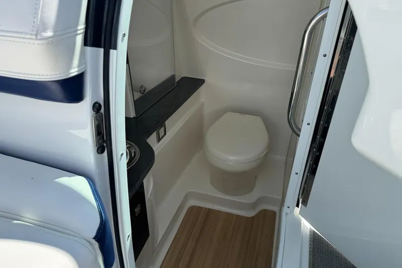 Slide: The Image of 2015 Formula 310 Bowrider interior bathroom with toilet and sleek design. - 24