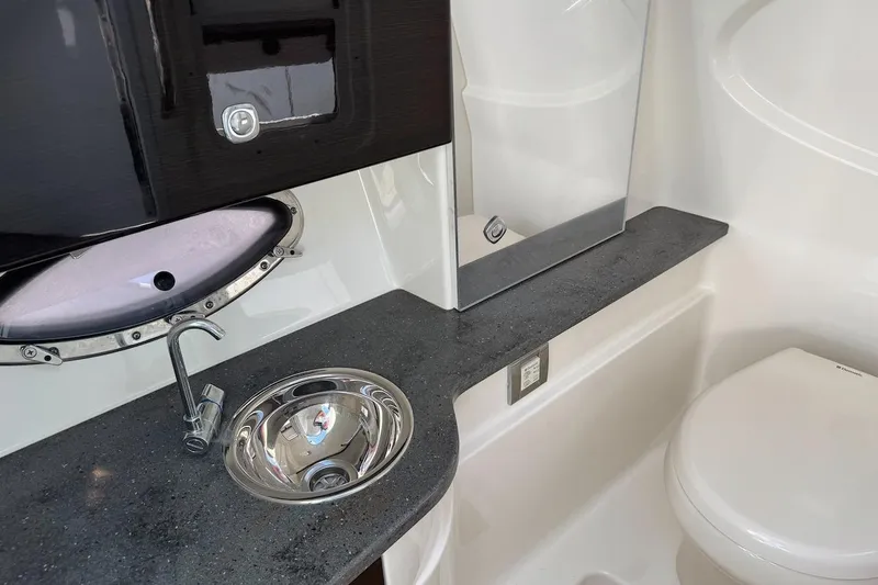 Slide: The Image of 2015 Formula 310 Bowrider bathroom with sink, faucet, and toilet. - 25