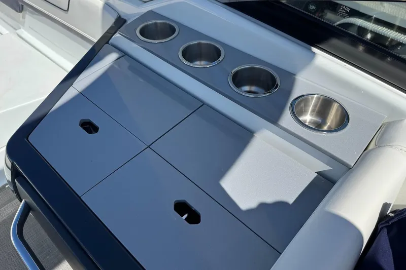 Slide: The Image of 2015 Formula 310 Bowrider boat console with cup holders and storage compartments. - 27