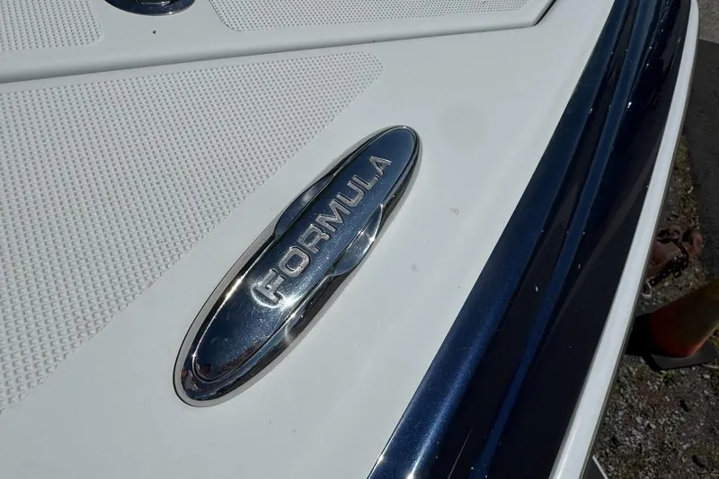 Slide: The Image of 2015 Formula 310 Bowrider boat emblem on white and blue surface. - 29