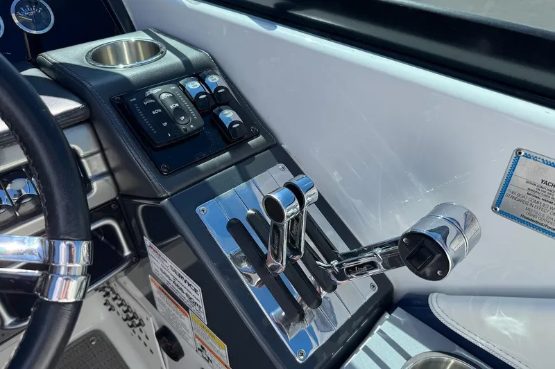 Slide: The Image of Control panel of a 2015 Formula 310 Bowrider boat with throttle levers and switches. - 7
