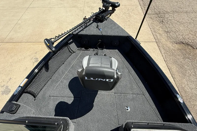 Slide: The Image of 2026 Lund 1875 Impact XS Sport boat interior with seating and trolling motor. - 10