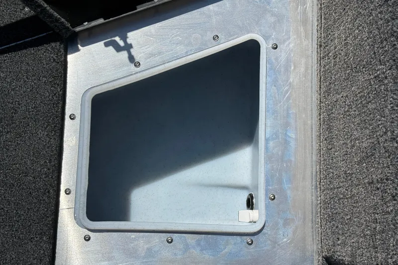Slide: The Image of Storage compartment of 2026 Lund 1875 Impact XS Sport boat, open and empty. - 14
