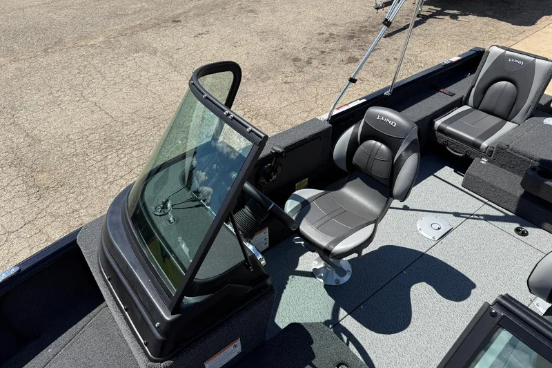Slide: The Image of 2026 Lund 1875 Impact XS Sport boat interior with seating and windshield. - 16