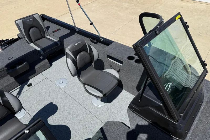 Slide: The Image of 2026 Lund 1875 Impact XS Sport boat interior with seating and windshield. - 17