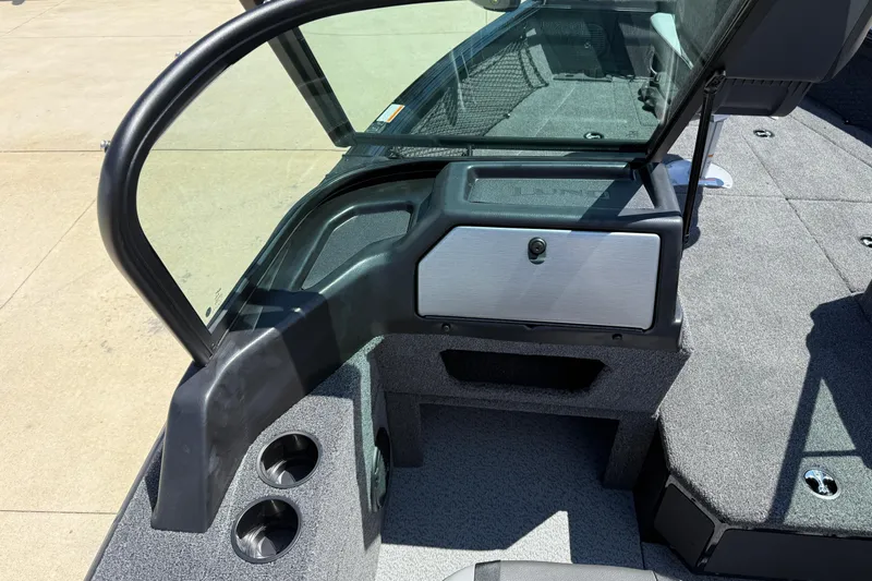 Slide: The Image of 2026 Lund 1875 Impact XS Sport boat interior with windshield and storage compartment. - 21