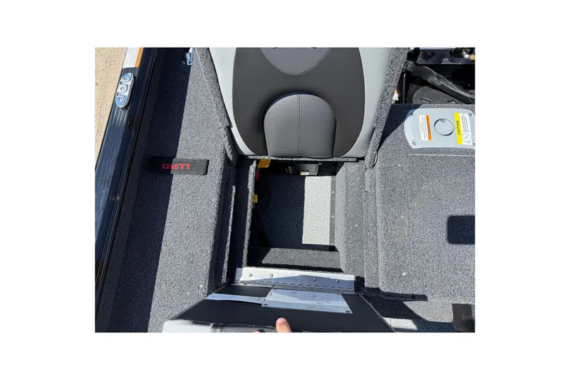 Slide: The Image of Interior view of 2026 Lund 1875 Impact XS Sport boat, featuring seating and storage area. - 29
