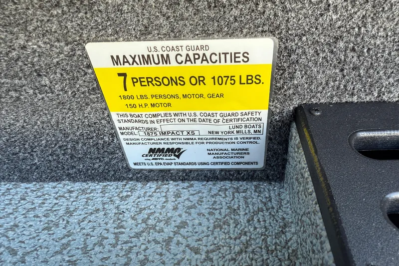 Slide: The Image of 2026 Lund 1875 Impact XS Sport capacity label, 7 persons or 1075 lbs, 150 HP motor. - 30