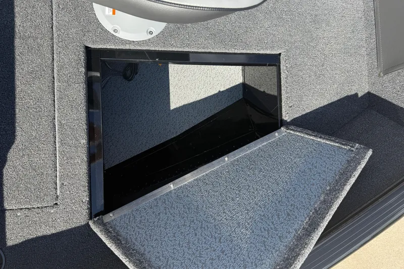 Slide: The Image of Open storage compartment on 2026 Lund 1650 Rebel XL Sport boat deck. - 11