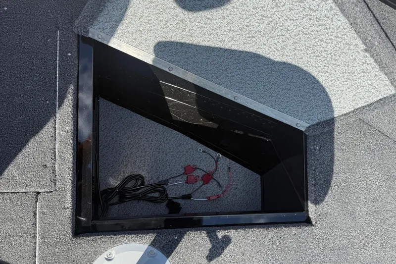 Slide: The Image of 2026 Lund 1650 Rebel XL Sport boat interior with seating and windshield. - 12