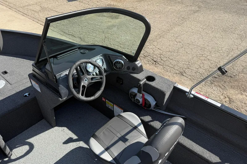 Slide: The Image of 2026 Lund 1650 Rebel XL Sport boat cockpit with steering wheel and dashboard controls. - 15