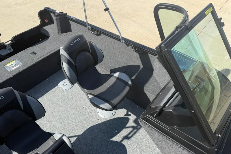 Slide: The Image of 2026 Lund 1650 Rebel XL Sport boat interior with seating and windshield. - 17