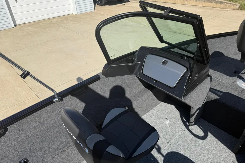 Slide: The Image of 2026 Lund 1650 Rebel XL Sport boat interior with open storage compartment. - 18